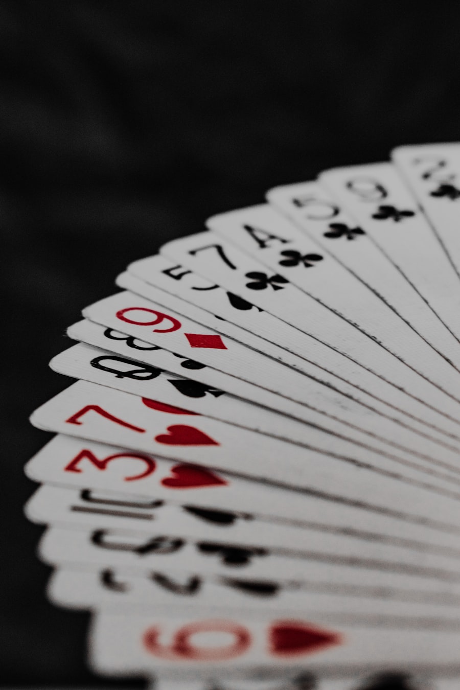 Fanned deck of playing cards on a dark table