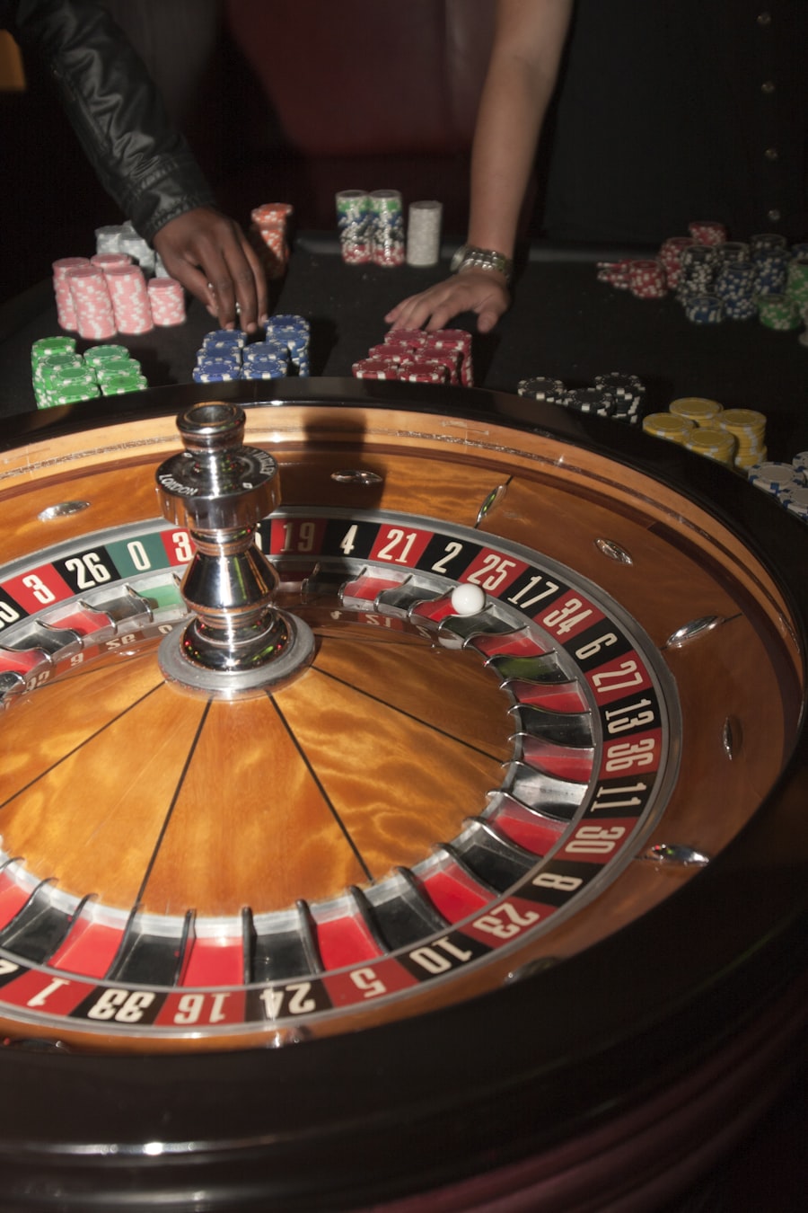 Live roulette wheel with croupier placing chips